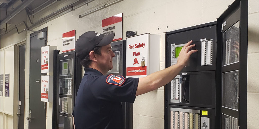 Fire inspector at a fire panel