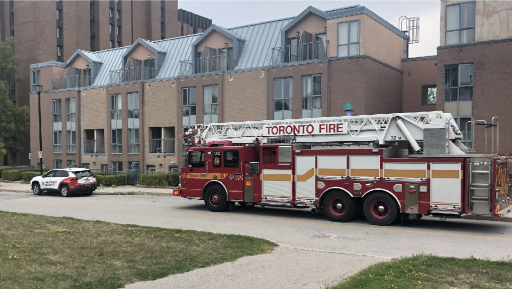 Security patrol vehicle escorting Toronto Fire Services to a residence