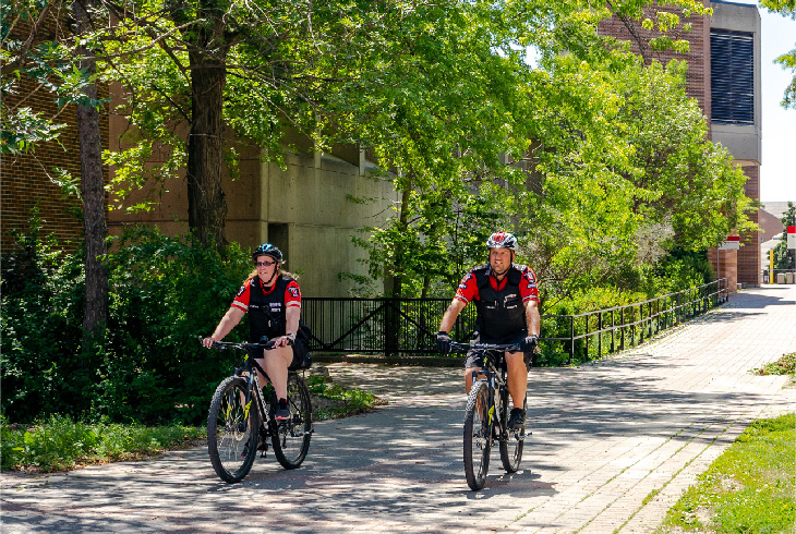 Two Security Officials on Bicycles