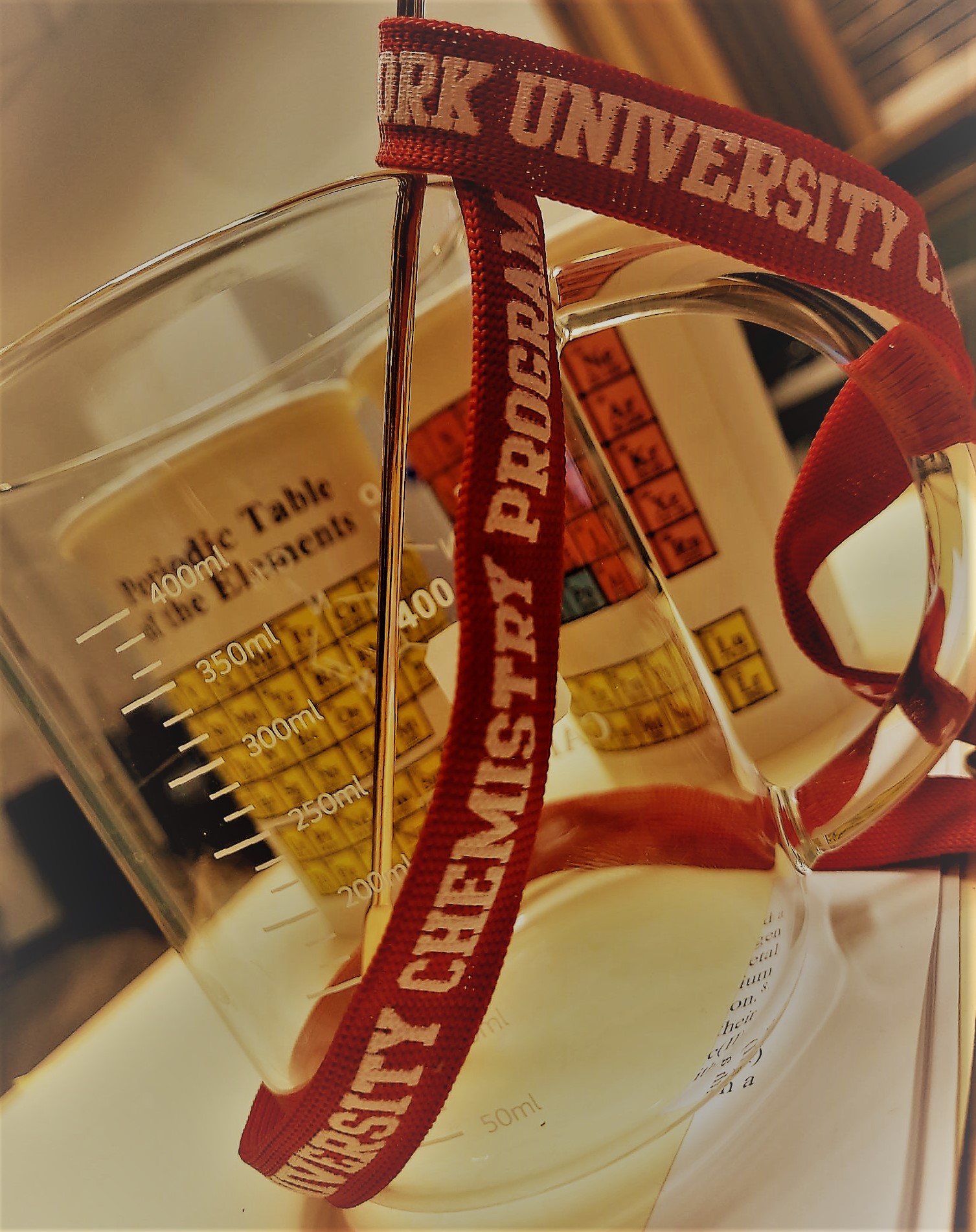 Photo of a mug with a lanyard saying Chemistry Program wrapped around it