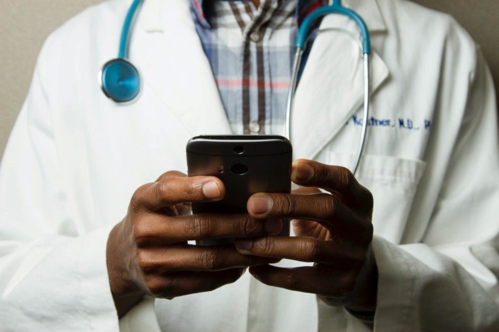 Healthcare worker texting on a phone