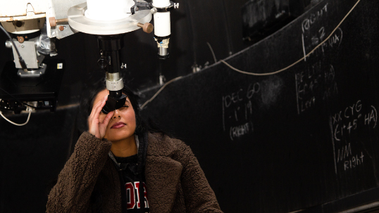 Woman looking through the telescope at the York Observatory