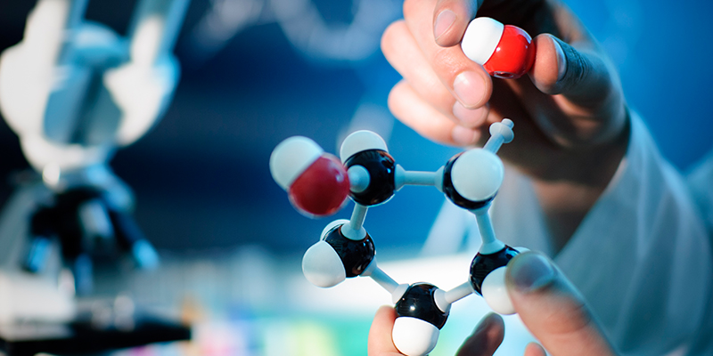 Person's hand in lab holding chemistry object