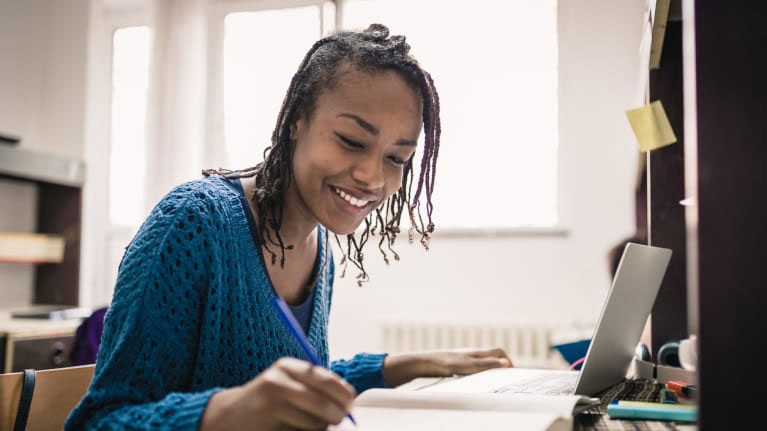 Female student studying in dorm room.