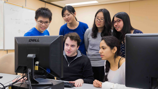 Six students looking at a computer screen