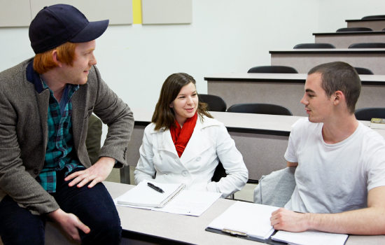 Teaching Assistant speaking with students