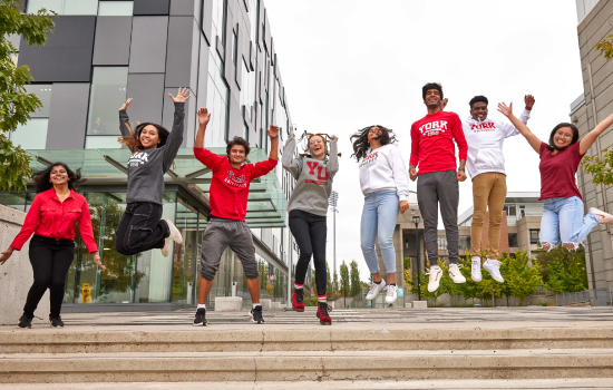 York students jumping in front of the Life Sciences Building