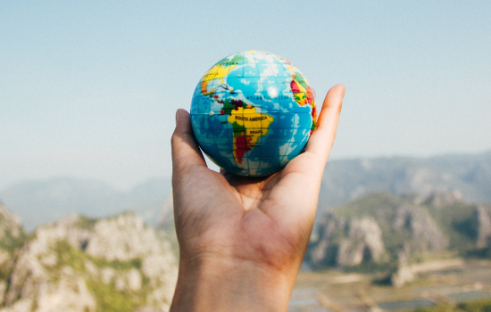 Hand holding a globe