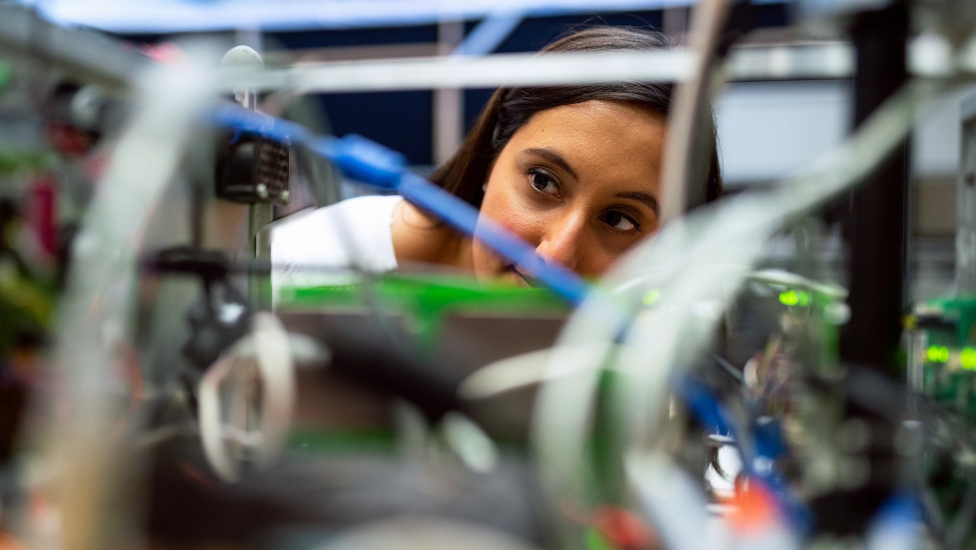 Woman looking through wires