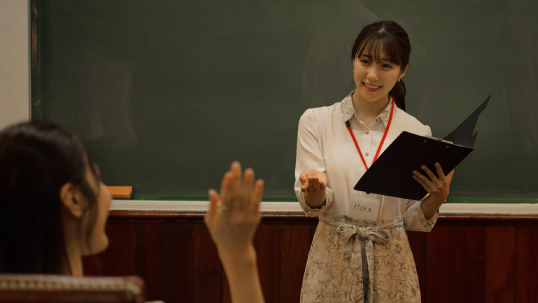 Woman teaching in front of students