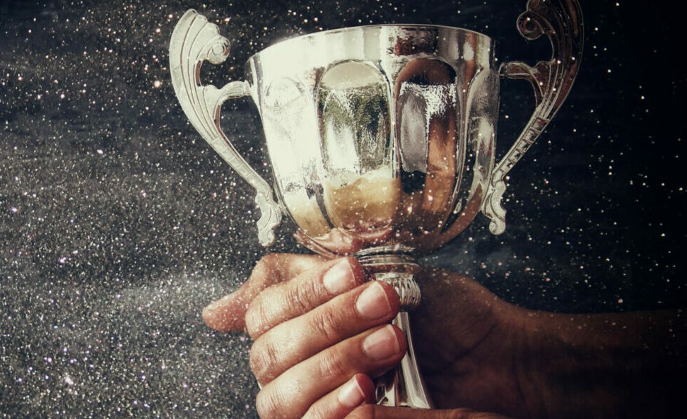 Image of a man holding a trophy cup