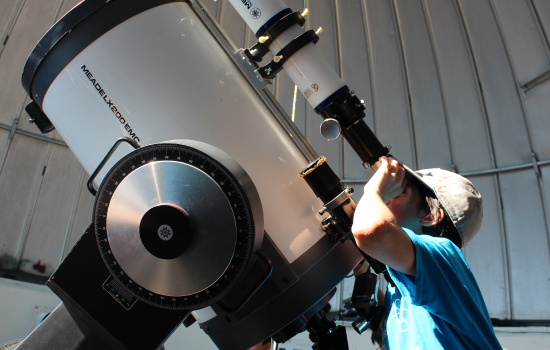 A child looking through the telescope at the York Observatory