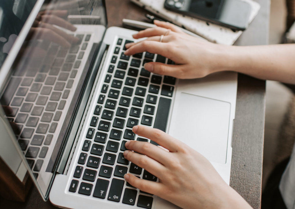 Female hands typing on a laptop