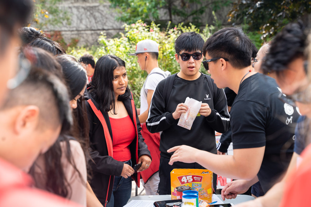 Students in a discussion amidst a crowd at York Fest.