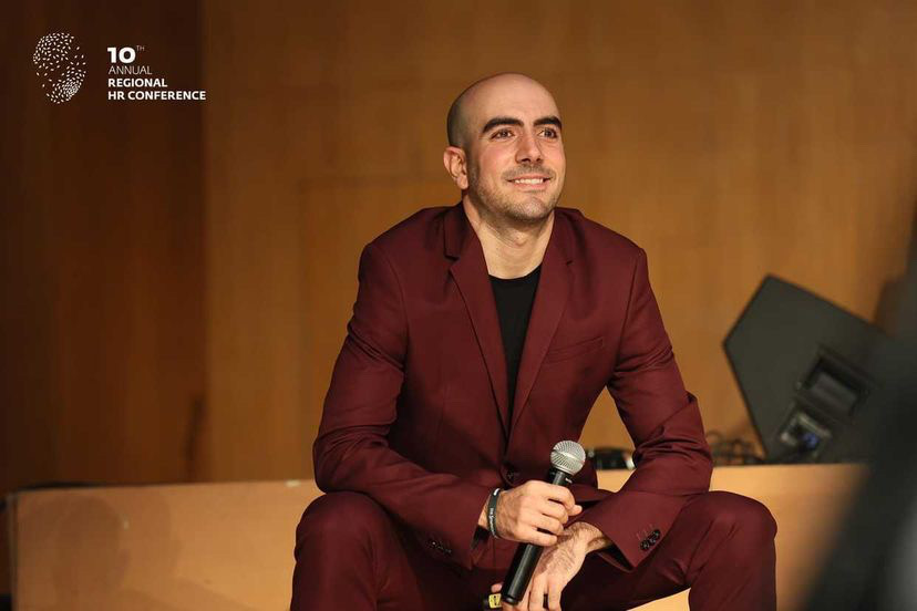 Speaker: Joze Piranian. Seated, smiling, wearing a burgundy suit and smiling.