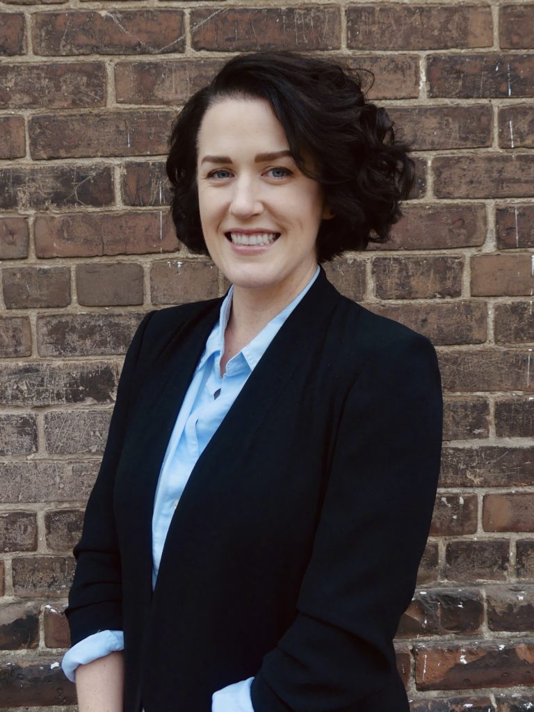 Closeup of Vanessa Evans in front of a brick wall