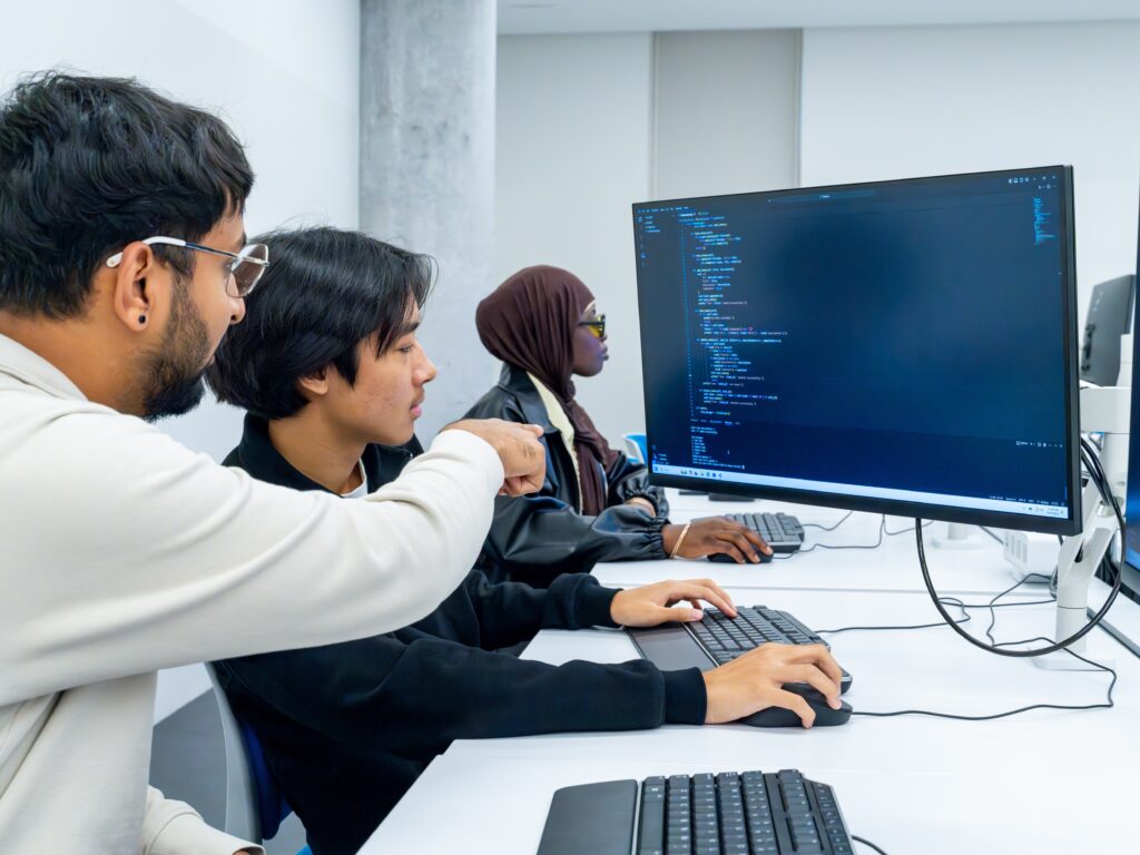 students in a computer lab writing code together