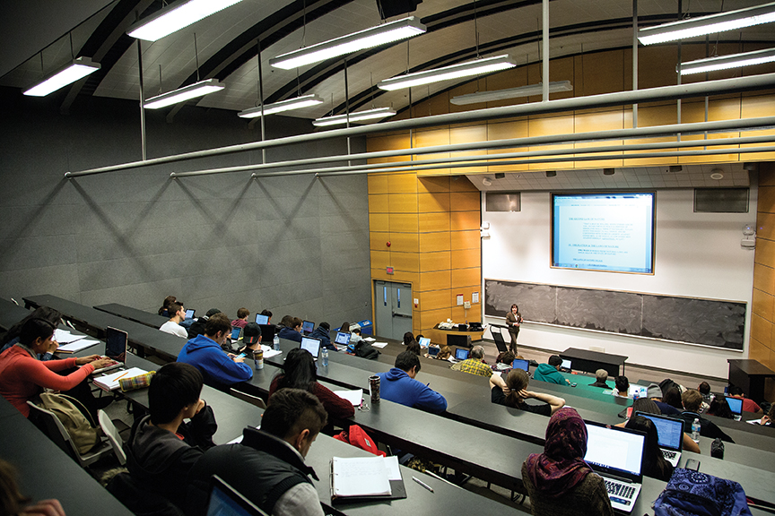 instructor communicating to lecture hall full of students