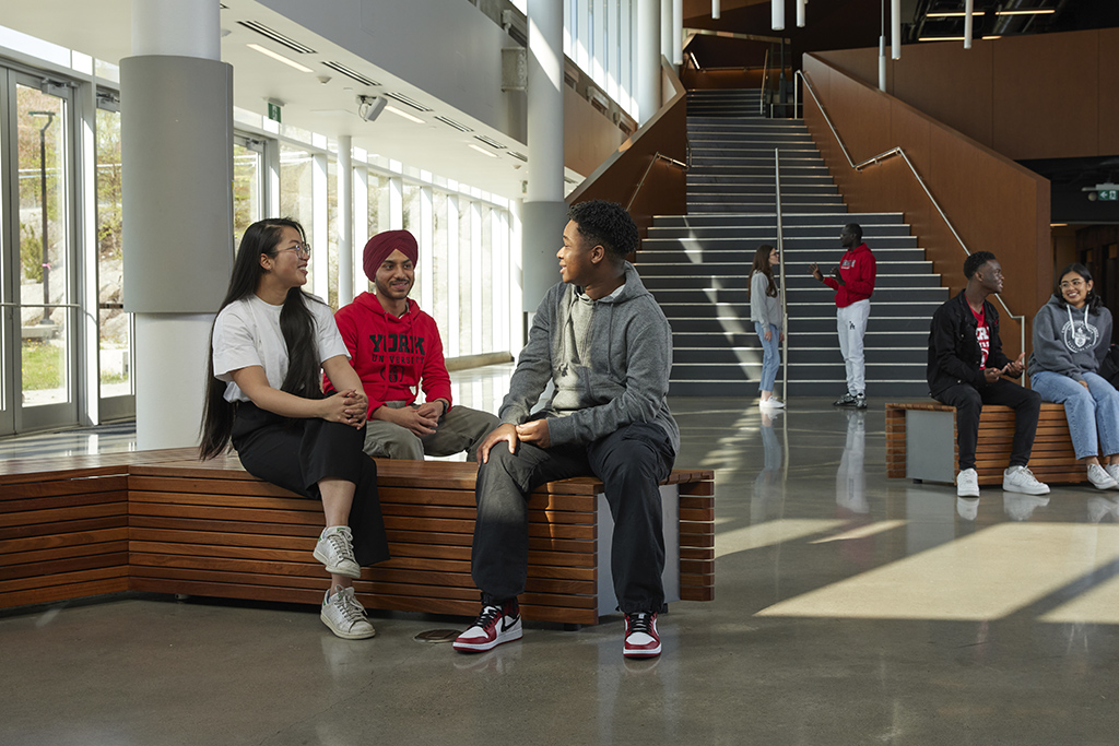 A group of students sitting together in the Second Student Centre and chatting 
