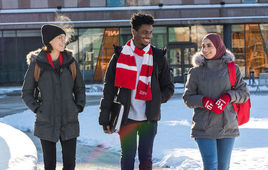Three York students in winter attire walking outside