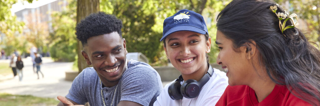 students on campus talking and sitting outside