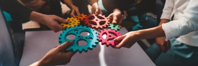 Teamwork of business people work together and combine pieces of gears