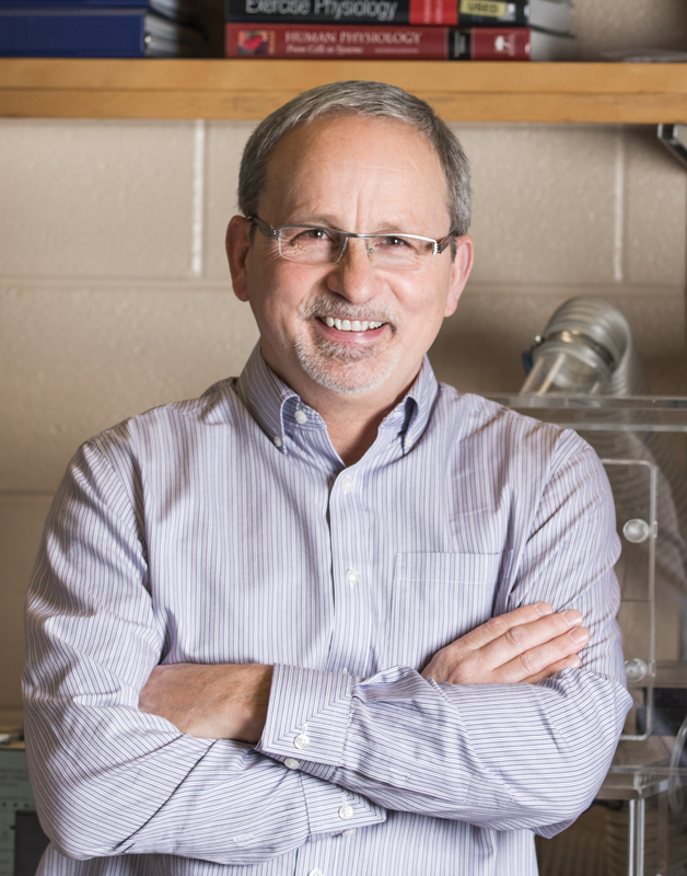 Dr. David Hood smiling with arms crossed.