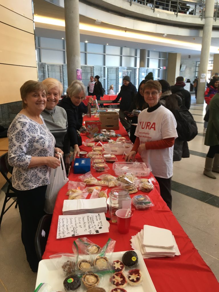 Four YURA volunteers working the Bake Table at the 2019 Showcase event
