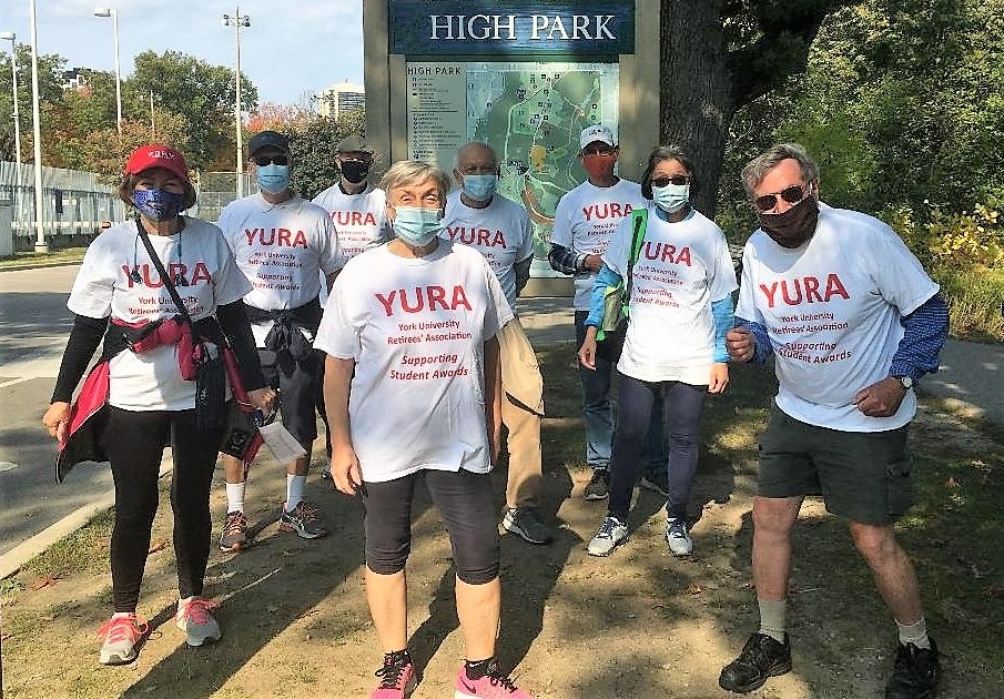 Eight YURA members, wearing YURA t-shirts, gathered in front of the High Park sign ready to complete a 5 km walk/run.