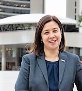 Head & shoulders photo of Dr. Eileen de Villa in front of Toronto City Hall